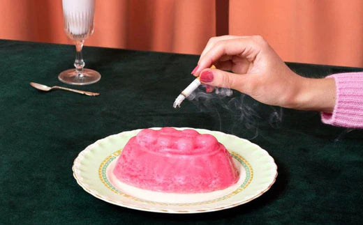 Stubbing out a cigarette on a plate of jelly