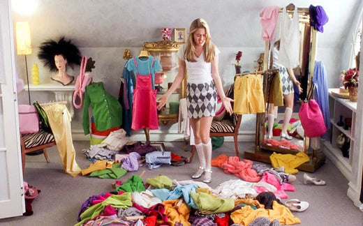 Cher from Clueless surrounded by clothes